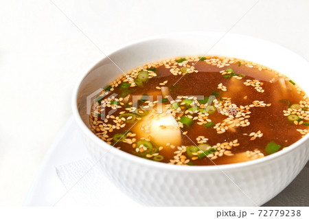 Udon noodle soup, with chicken fillet slices, egg, garnished with green onions Udon noodle soup, with chicken fillet slices, egg, garnished with green onions 72779238