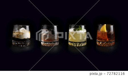 Set of classic cold alcoholic cocktails in transparent glasses on a black background. White Russian, Bramble, Whiskey Sour and Negroni. Set of classic cold alcoholic cocktails in transparent glasses on a black background. White Russian, Bramble, Whiskey Sour and Negroni. 72782116