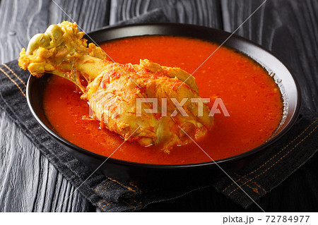 Central American turkey soup in red vegetable broth with spices close-up in a bowl. horizontal Central American turkey soup in red vegetable broth with spices close-up in a bowl. horizontal 72784977