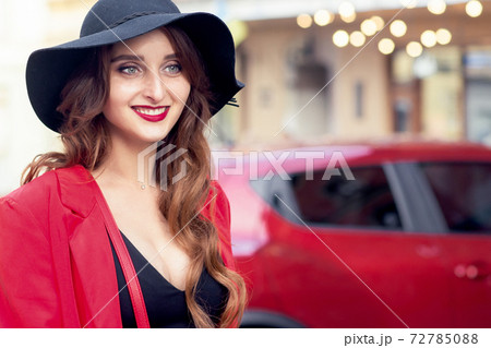 Woman on background of red car. Woman on background of red car. 72785088