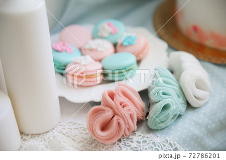 pink and turquoise macaroons and delicate jewelry made of chiffon. pink and turquoise macaroons and delicate jewelry made of chiffon. 72786201