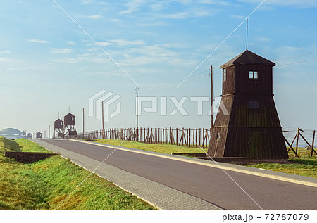 Road of Homage and Remembrance with barbed wire fences and a watchtowers in German concentration and extermination camp Majdanek. Lublin, Poland 72787079