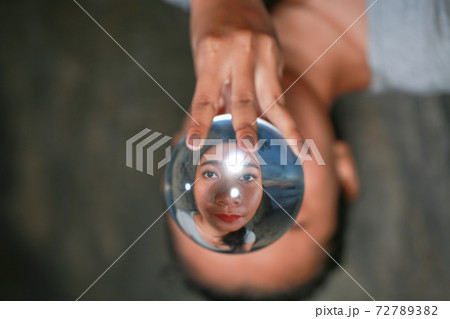 The face of a woman in a crystal ball 72789382