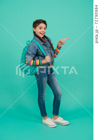 Get what you eye. Happy child pointing finger blue background 72790984