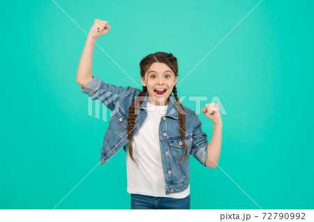 Happy child celebrate victory making winning gesture keeping fists raised blue background, winner Happy child celebrate victory making winning gesture keeping fists raised blue background, winner 72790992