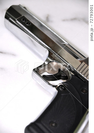Chrome metal gun on white marble, powerful weapon Desert Eagle Chrome metal gun on white marble, powerful weapon Desert Eagle 72793001