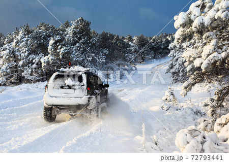 One SUV 4x4 cars go on snowy road, winter season One SUV 4x4 cars go on snowy road, winter season 72793441