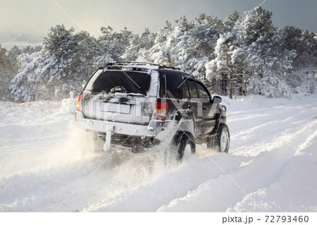 One SUV 4x4 cars go on snowy road, winter season One SUV 4x4 cars go on snowy road, winter season 72793460