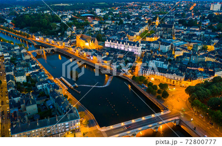 Evening aerial view of Laval with buildings, river Mayenne and old bridge 72800777