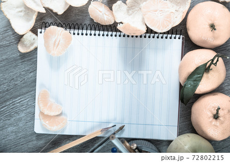 Empty notebook pages and tangerines Empty notebook pages and tangerines 72802215