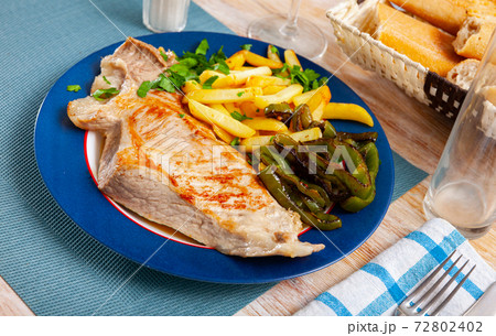 Fried Iberian pig served with potatoes, parsley, stewed pepper 72802402