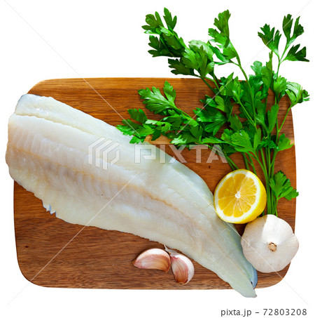 Raw cod fillet with garlic and lemon 72803208