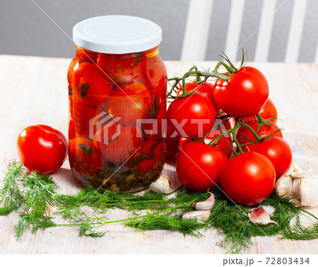 Pickled tomatoes in glass jar 72803434