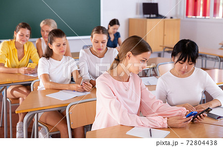 Students working in pairs using phones 72804438