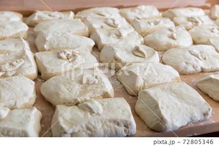 Raw dough divided into portioned pieces on baker worktable Raw dough divided into portioned pieces on baker worktable 72805346
