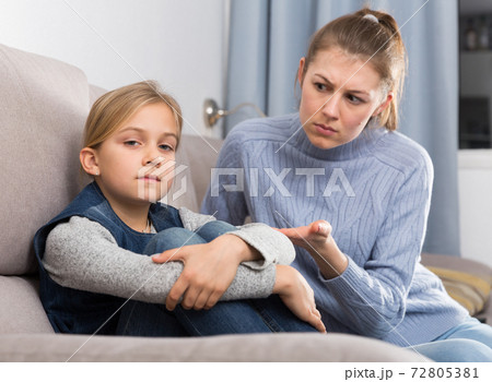 Woman scolding her daughter 72805381