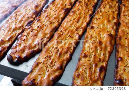 Closeup of freshly baked cocas with sesame seeds in bakery Closeup of freshly baked cocas with sesame seeds in bakery 72805398