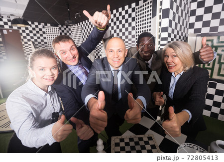 Colleagues having fun in escape room 72805413