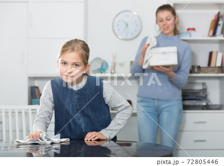Girl helping mother with cleaning 72805446