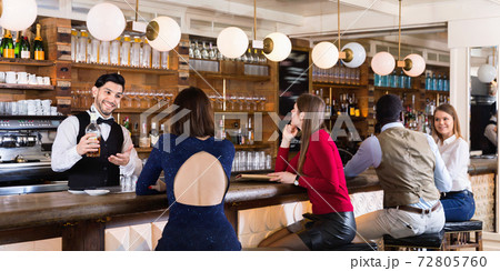 Portrait of barman and people who are standing near bar counter in luxurious restaurant 72805760