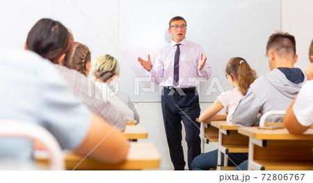 Male teacher lecturing to students at classroom 72806767