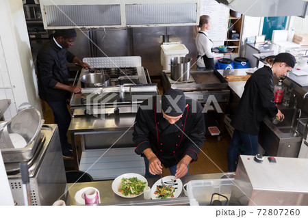 Staff of restaurant with chef working 72807260