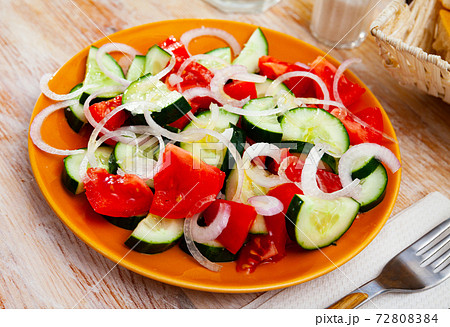 Vegetarian salad with fresh cucumbers, tomatoes, onion 72808384