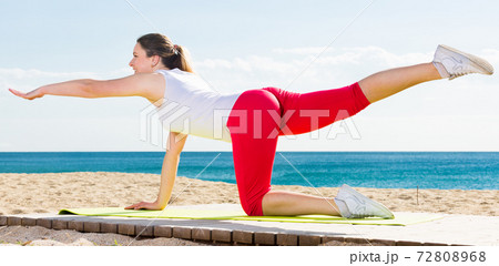 Woman doing yoga sitting 72808968