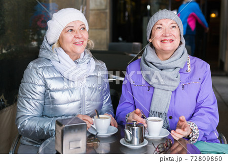 Smiling elderly females at outdoor cafe Smiling elderly females at outdoor cafe 72809860