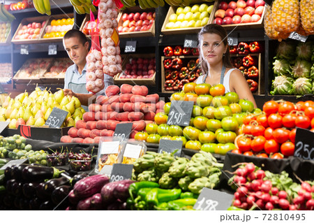 Female seller offering vegetables on market Female seller offering vegetables on market 72810495