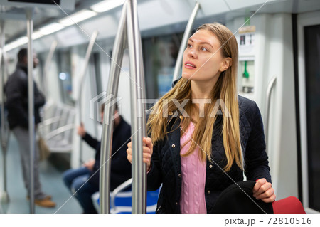 Young woman in subway car 72810516