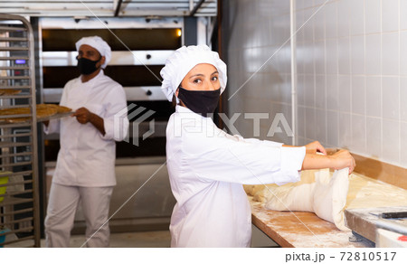 Woman baker kneading dough for baking bread Woman baker kneading dough for baking bread 72810517
