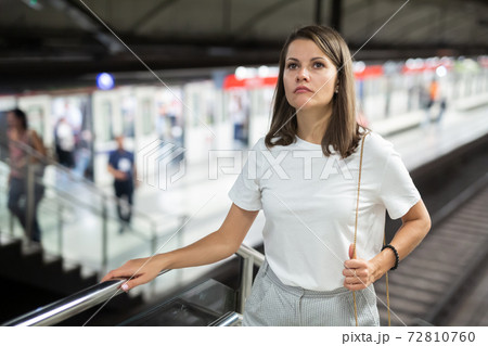 Girl coming out of subway station 72810760