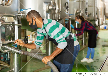 Male worker in mask working at winery Male worker in mask working at winery 72810793