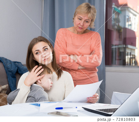 Woman is outraged of utility bills and quarreling with her mother 72810803