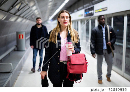 Female passenger waiting for subway train Female passenger waiting for subway train 72810956