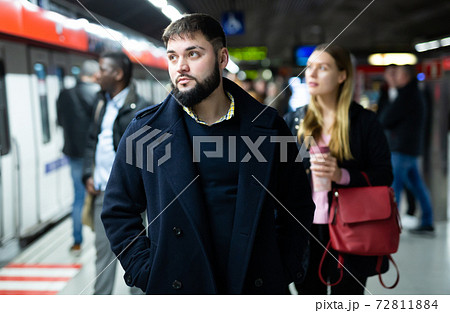 Young man waiting for subway train Young man waiting for subway train 72811884