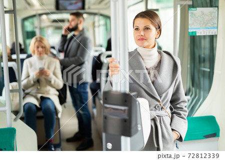 Pretty woman in public land transport 72812339