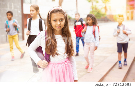 Teenage girl with backpack going to school on autumn day 72812692