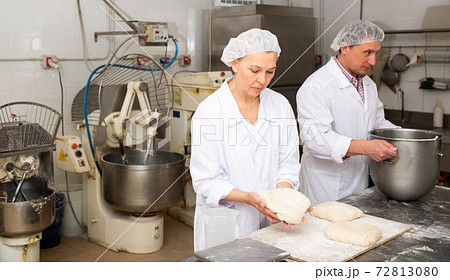 Woman baker forming dough for baking bread Woman baker forming dough for baking bread 72813080