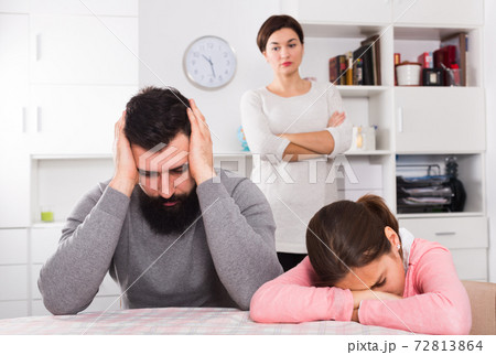 Mother lecturing husband and daughter Mother lecturing husband and daughter 72813864
