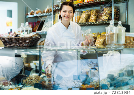 Girl in uniform selling candied fruits and nuts Girl in uniform selling candied fruits and nuts 72813984