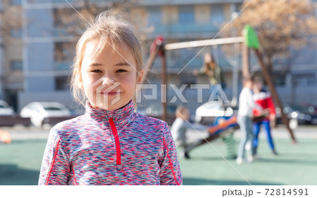 Little girl standing on playground 72814591