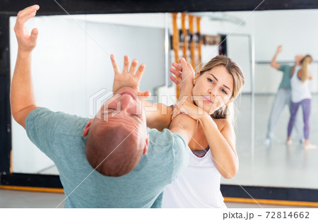 Woman practicing basic palm strike in self defense training 72814662