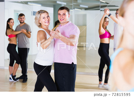 Dancing couples learning salsa at dance class 72815595