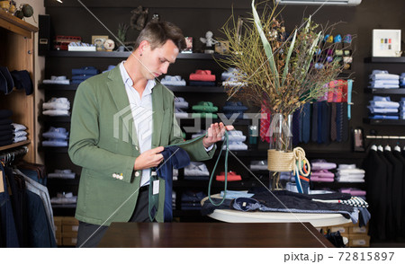 Guy deciding on new tie 72815897