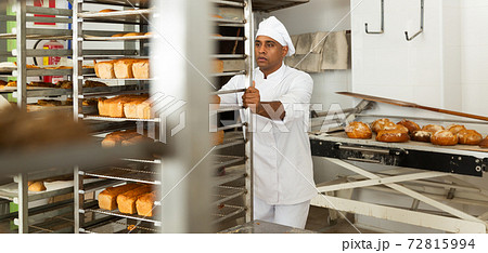 Baker transporting hot bread cart Baker transporting hot bread cart 72815994