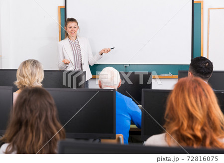 Young female trainer giving presentation Young female trainer giving presentation 72816075