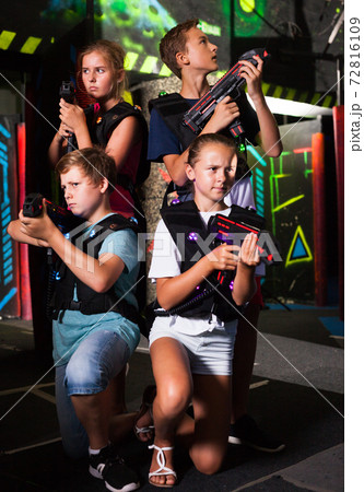 Girls and boys posing with laser pistols Girls and boys posing with laser pistols 72816109