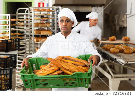 man in chefs uniform with bread in tray in bakery man in chefs uniform with bread in tray in bakery 72816331